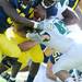 Michigan junior quarterback Denard Robinson is tackled by Eastern Michigan linebacker Desdan Hester during the second quarter against Eastern Michigan at Michigan Stadium on Saturday. Melanie Maxwell I AnnArbor.com